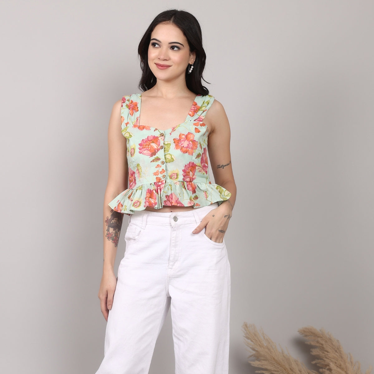 Insaneful Garden Whimsy – women’s cotton floral peplum top in pastel green with pink flower print, styled with white high-waist trousers.
