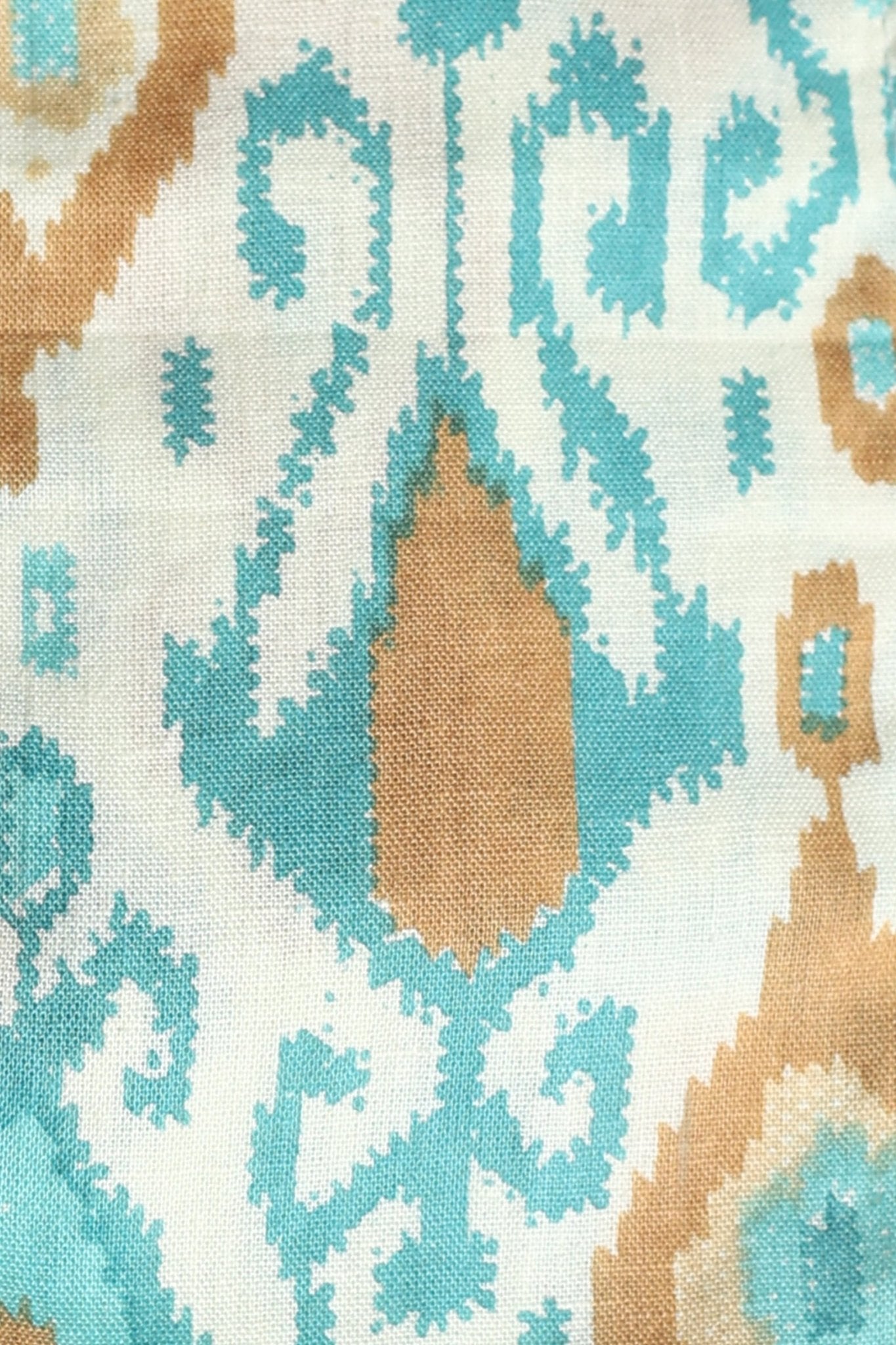 Sleeveless cream corset top with aqua blue and mustard ikat print, square neckline, deep U back, and fitted waist in cotton fabric