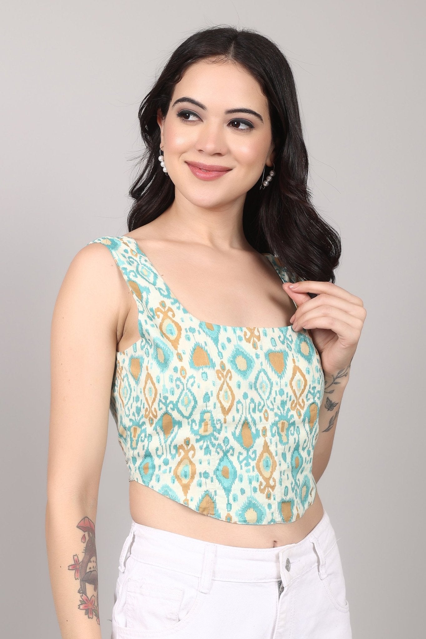 Sleeveless cream corset top with aqua blue and mustard ikat print, square neckline, deep U back, and fitted waist in cotton fabric