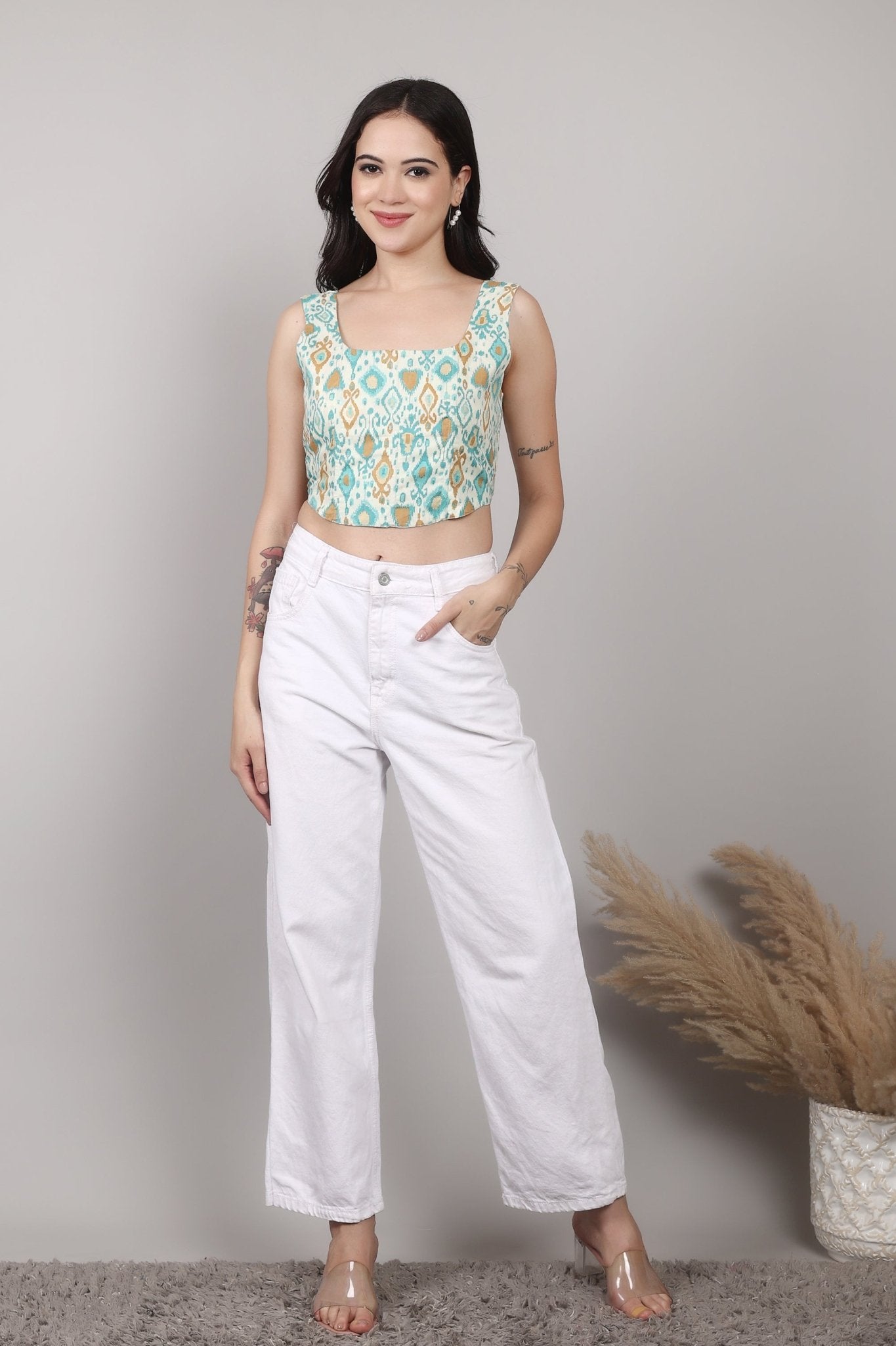 Sleeveless cream corset top with aqua blue and mustard ikat print, square neckline, deep U back, and fitted waist in cotton fabric