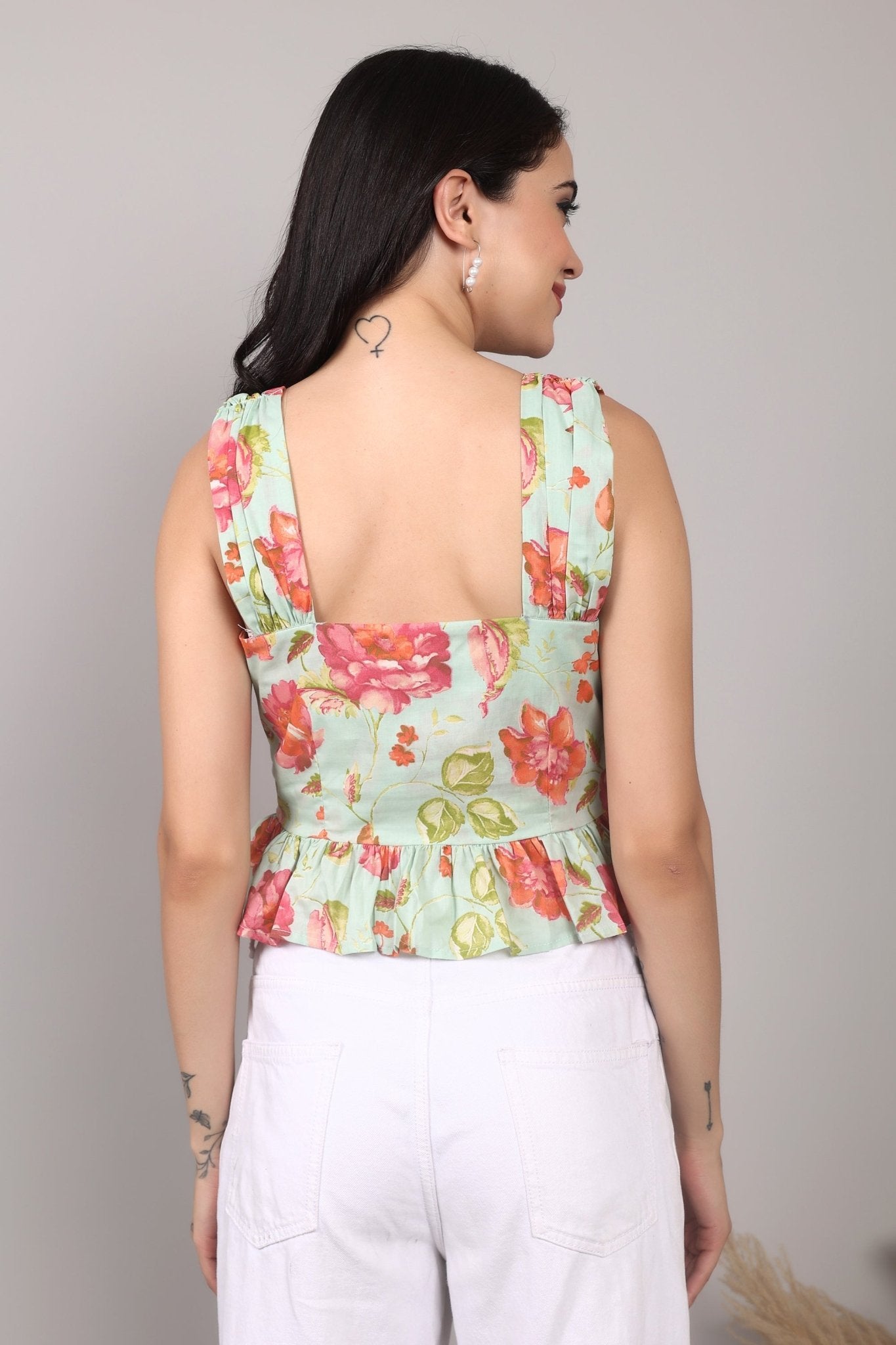 Sleeveless mint green 100% cotton peplum top with vibrant pink and orange floral print, wide straps, sweetheart neckline, button-down front, and ruffled hem