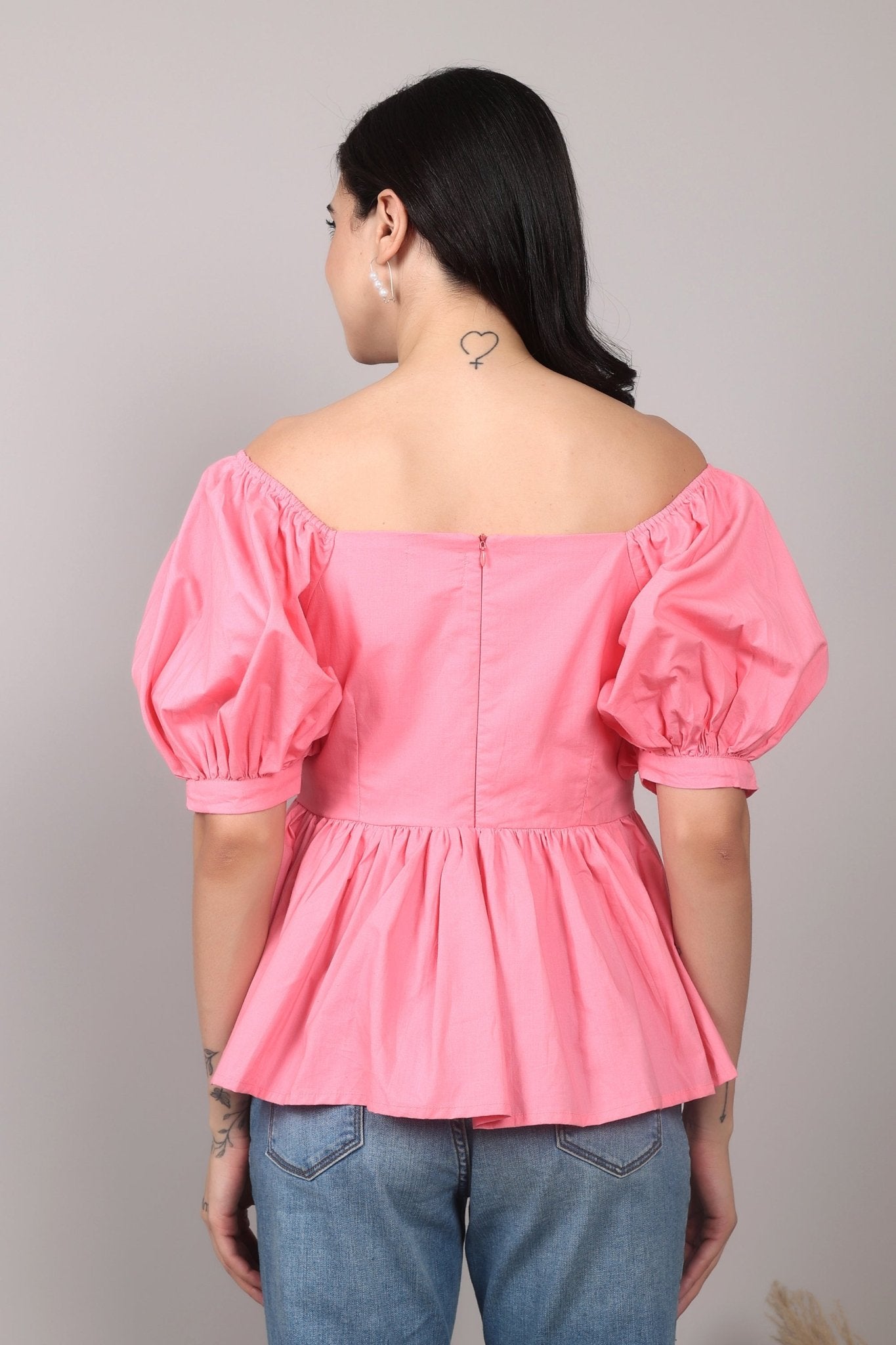 Soft pink 100% cotton peplum top with exaggerated puff sleeves, square neckline, gathered bust detailing, and a breezy relaxed fit for an effortlessly feminine look.
