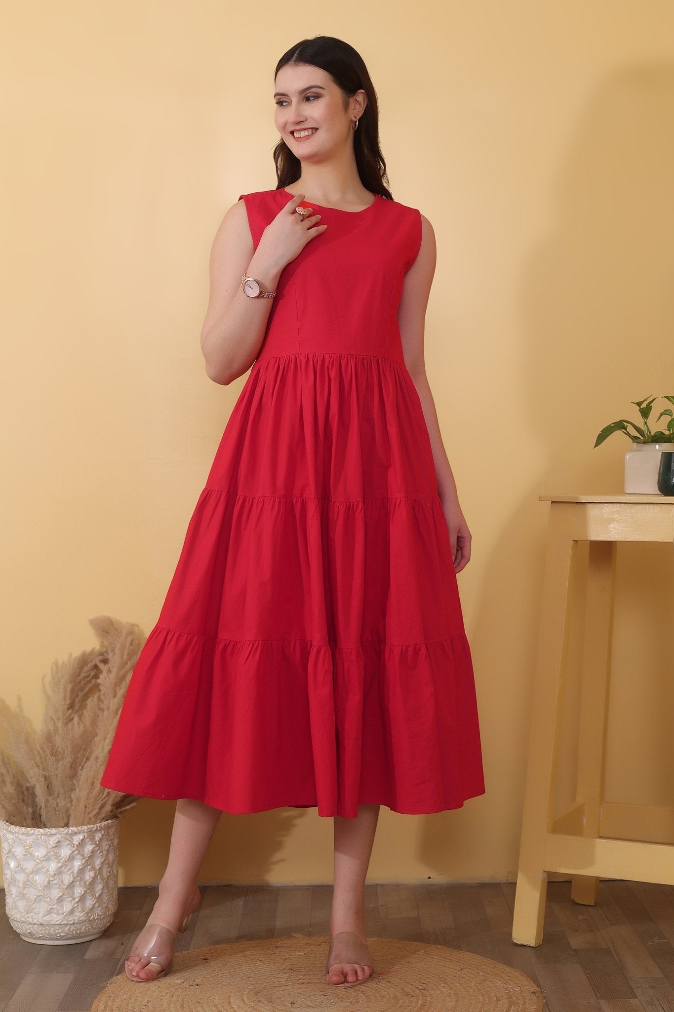 Bold red cotton poplin dress with sleeveless fit-and-flare shape, tiered hem, and a dramatic open back detailed with a tie-up bow closure.