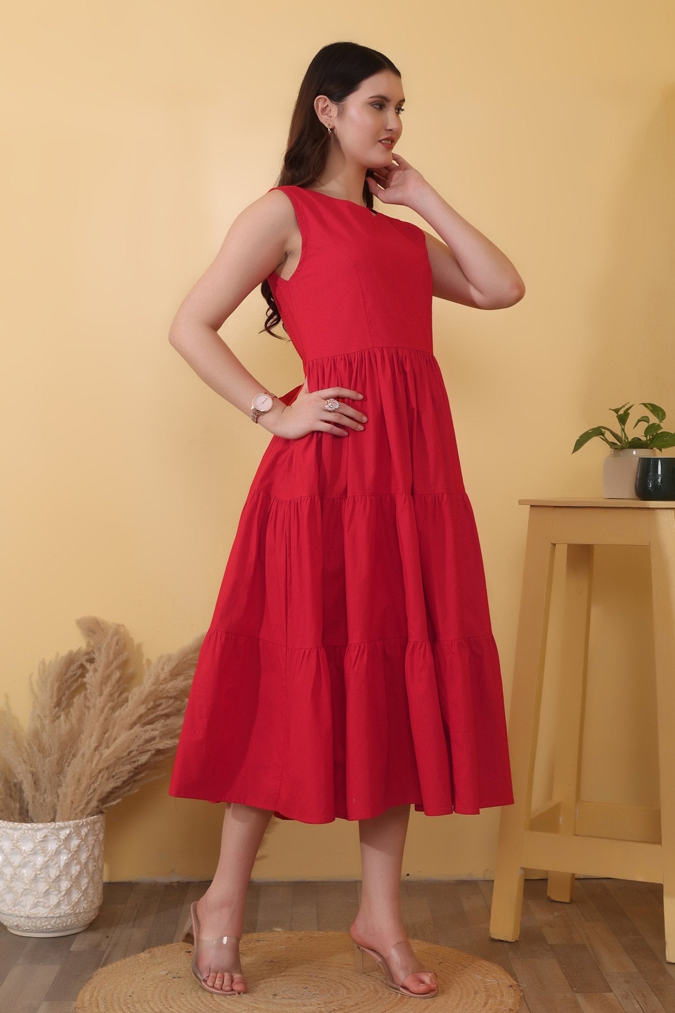 Bold red cotton poplin dress with sleeveless fit-and-flare shape, tiered hem, and a dramatic open back detailed with a tie-up bow closure.