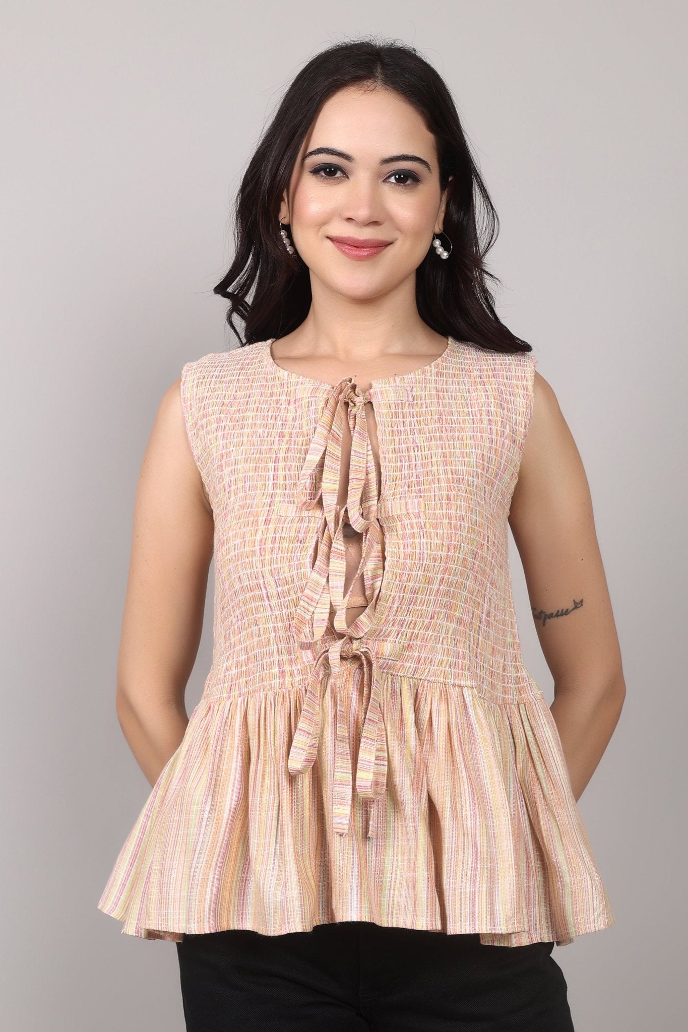 Beige sleeveless cotton-blend top with multicolor striped weave, smocked bodice, triple-tie front keyhole, and flared peplum hem—relaxed and breezy.