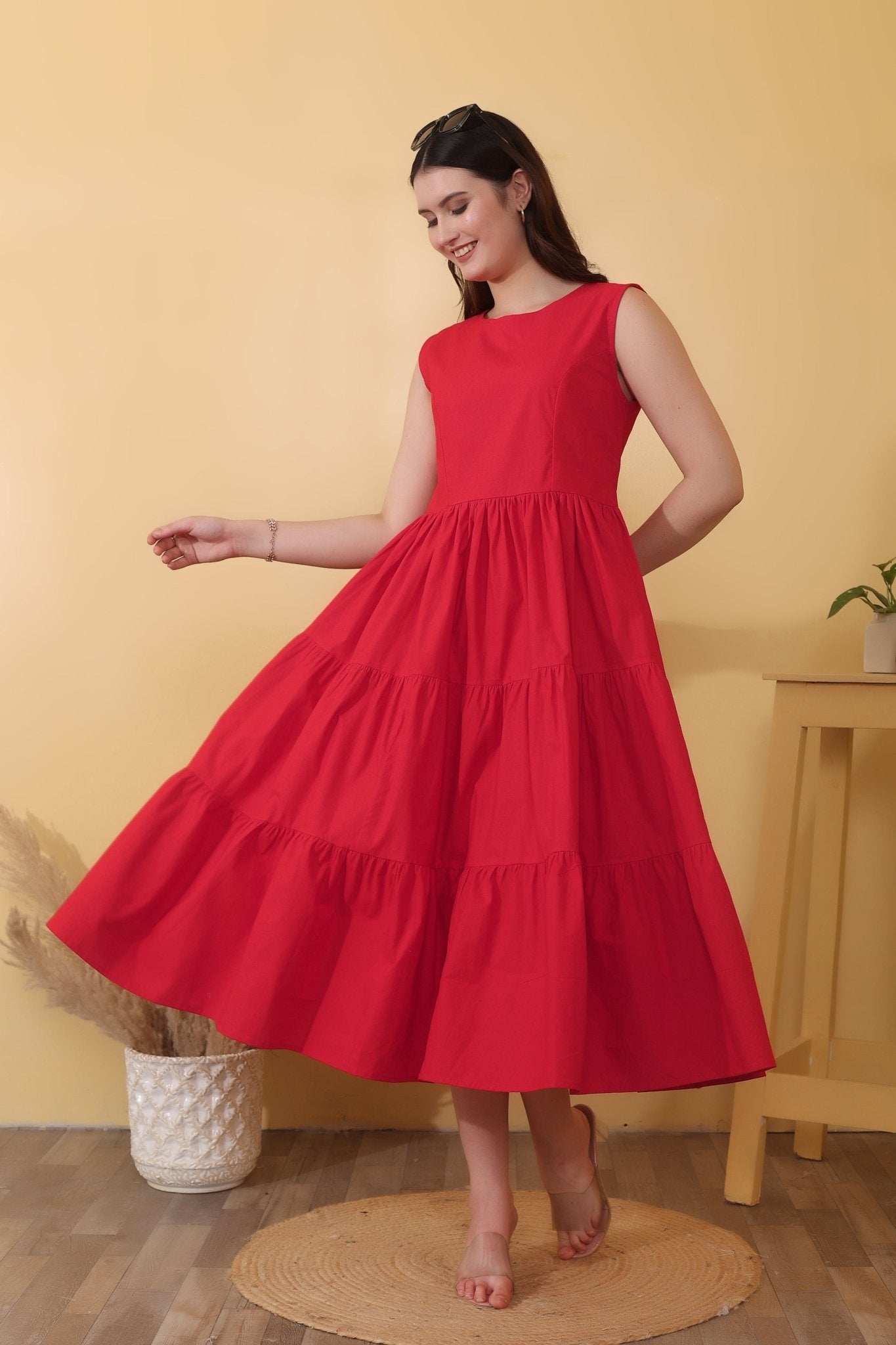 Bold red cotton poplin dress with sleeveless fit-and-flare shape, tiered hem, and a dramatic open back detailed with a tie-up bow closure.