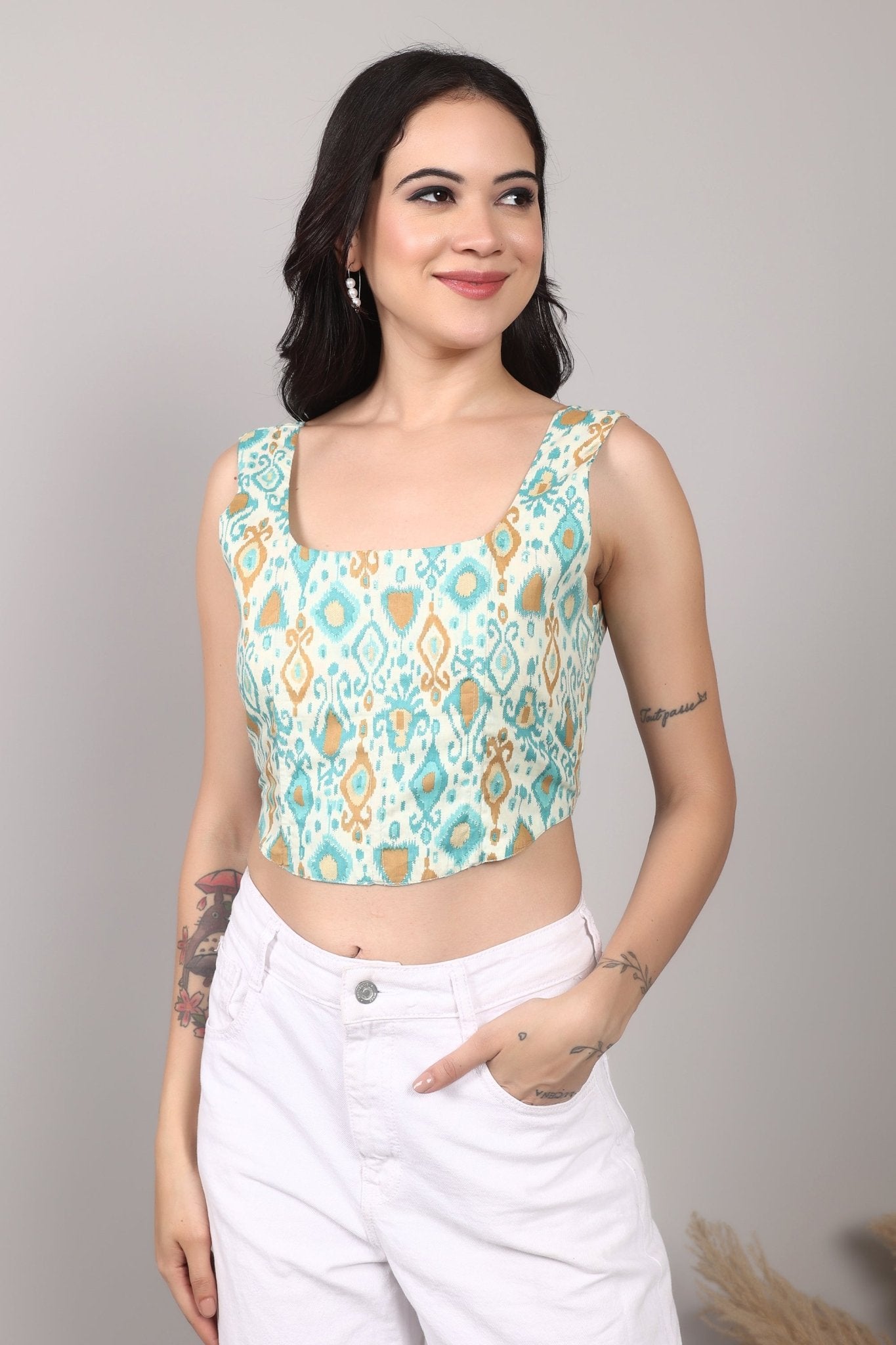 Sleeveless cream corset top with aqua blue and mustard ikat print, square neckline, deep U back, and fitted waist in cotton fabric