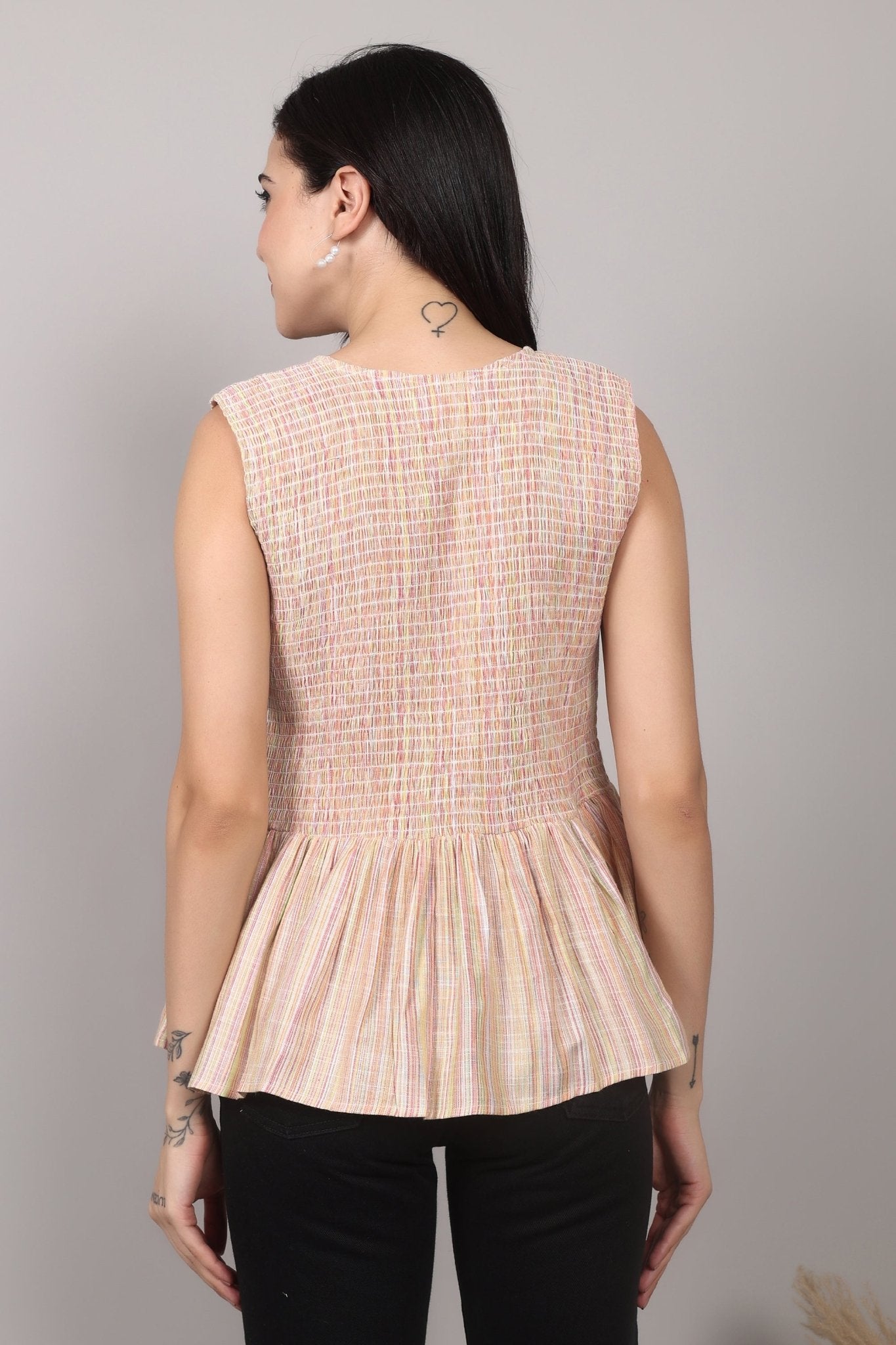 Beige sleeveless cotton-blend top with multicolor striped weave, smocked bodice, triple-tie front keyhole, and flared peplum hem—relaxed and breezy.